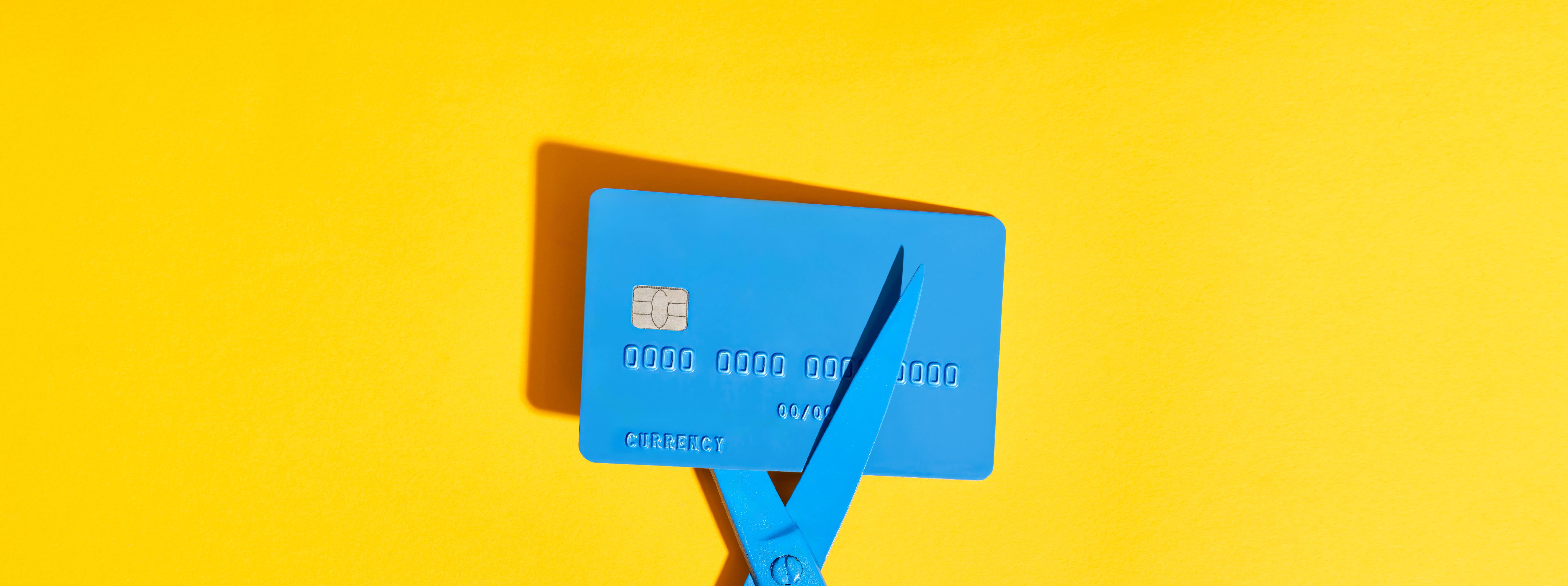 blue-scissors-cutting-credit-card-on-yellow-backgr-2026-01-25-00-19-16-utc.jpg