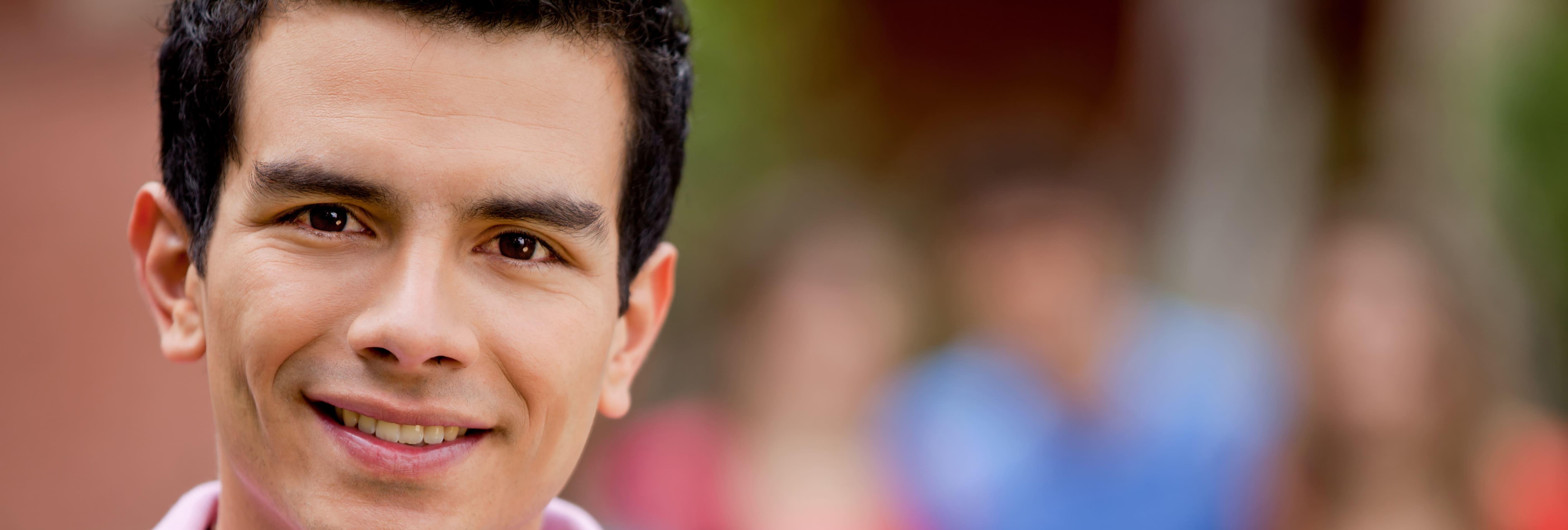 casual-man-smiling-outdoors-with-a-group-behind-hi-2026-01-09-14-56-01-utc.jpg